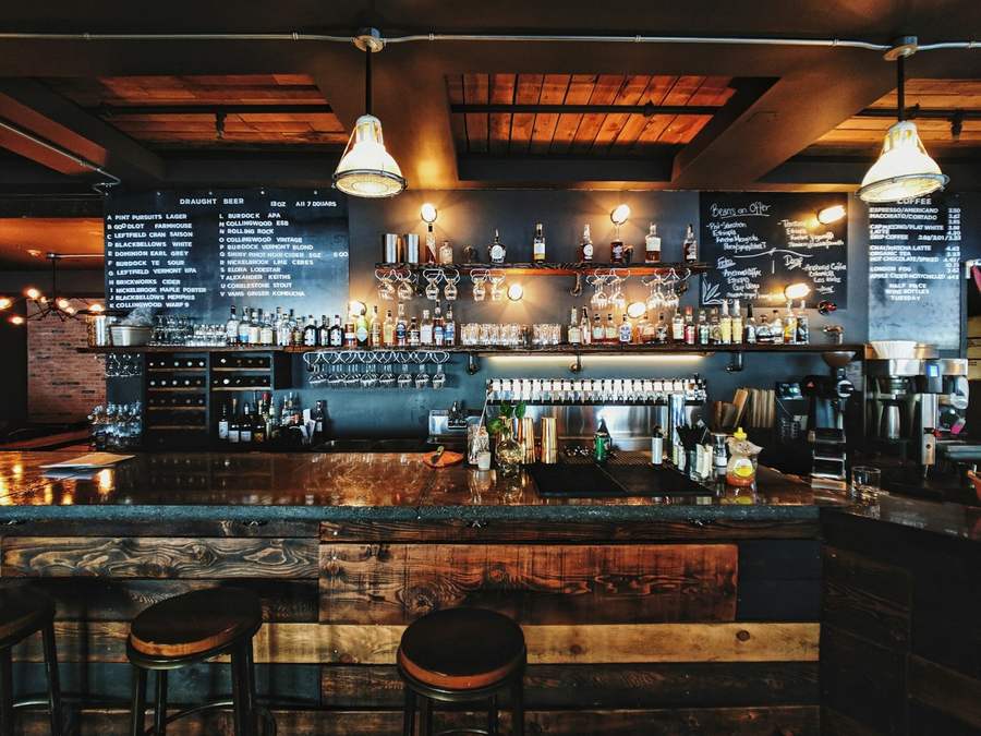 Bar interior with a row of beer taps and a chalkboard drinks menu