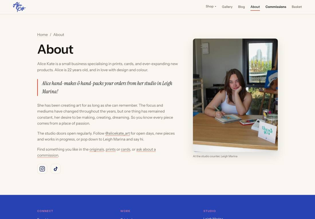 The about page on alicekate.art with Alice's bio and a photo of her sketching at the studio counter